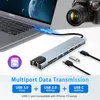 A multiport USB hub connected to a laptop, with a camera in the background and various USB devices. Produktbild-Vorschau