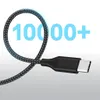 A close-up of a USB-C cable with a braided nylon exterior, coiled into a loop, with a large number "10000+" overlaid in blue text. Produktbild-Vorschau