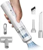 A hand holding a white handheld vacuum cleaner with various attachments. Produktbild-Vorschau