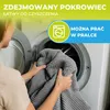 A person is putting a gray blanket into a washing machine. There is text overlaying the image that provides product information. Podgląd zdjęcia produktu