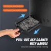 A hand is shown pulling out an ash drawer from a black fire pit. The ash drawer is filled with ashes. Text overlays highlight the features of the ash drawer. Anteprima dell’immagine prodotto