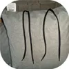 Close-up of gray fabric with black drawstrings. Náhled obrázku produktu
