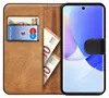 A book-style phone case with a phone inserted, showing cards and cash inside. Produktbild-Vorschau