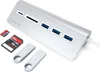 A silver Satechi USB-C hub with multiple ports and card slots, along with various memory cards and USB drives, is displayed on a white background. Náhled obrázku produktu