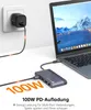 A USB-C docking station connected to a laptop, with a power adapter charging the laptop. Produktbild-Vorschau