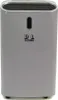 A light gray air purifier with a black top opening and an oval dark gray indicator light. Produktbild-Vorschau