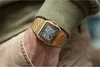 A close-up shot of a gold Casio watch on a person's wrist, with the sleeve of a green sweater visible. Produktbild-Vorschau