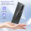 A hand holding a transparent phone case with feathers floating around. Produktbild-Vorschau