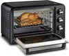 A black toaster oven with a roasted chicken and potatoes inside, with the door open. Voir les images du produit
