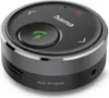 A close-up, studio shot of a circular black Bluetooth receiver with silver trim. Voir les images du produit