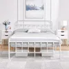 A white metal bed frame with bedding, flanked by two white nightstands, and a painting on the wall. Produktbild-Vorschau