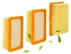 Three air filters with orange frames and yellow pleated paper elements, displayed diagonally against a white background with scattered green leaves. Produktbild-Vorschau