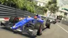 Formula 1 race cars on a track, with grandstands and trees in the background. Produktbild-Vorschau