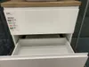 A white bathroom cabinet with a wooden top, one drawer open, showing a label with product information. Anteprima dell’immagine prodotto