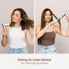 Two women are shown using a hair dryer and styling brush, demonstrating different hair styling techniques. Voir les images du produit