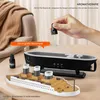 A hand is adding essential oil to a ship-shaped aromatherapy diffuser, with a small bottle of oil nearby. Produktbild-Vorschau