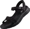 Auf dem Bild ist eine schwarze Sandale zu sehen die von der Seite abgebildet ist. Die Sandale hat ein schlichtes Design mit einem breiten Riemen über dem Fuß. Produktbild-Vorschau
