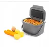 A gray compost bin filled with vegetable scraps, next to raw carrots and potatoes. Anteprima dell’immagine prodotto