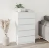 A white five-drawer chest of drawers stands against a white wall, next to a gray sofa. A potted plant and a stack of books are on top of the chest. A vase with dried reeds is to the left of the chest. Voir les images du produit