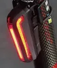 A close-up of a bicycle tail light attached to a carbon fiber seat post. Podgląd zdjęcia produktu