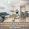 A modern living room and kitchen area with a vacuum cleaner placed on the floor. Anteprima dell’immagine prodotto