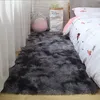 A bedroom scene with a fluffy rug in front of a bed, a Totoro plush toy, and a decorative paper bag. Náhled obrázku produktu
