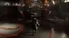 A person walks through a dimly lit, industrial-looking room with large, complex machinery in the center. Produktbild-Vorschau