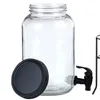 A clear product shot of a glass beverage dispenser with its lid and a black spigot. Produktbild-Vorschau