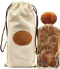 A perfume bottle and its fabric pouch are displayed against a white background. Náhľad obrázku produktu