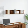 A wooden desk with a laptop and an open book, below a wooden wall shelf filled with books. Produktbild-Vorschau