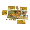 A board game setup with various game pieces and boards laid out on a white background. Produktbild-Vorschau