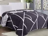 A bed with a patterned blanket and white pillows. Podgląd zdjęcia produktu