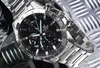 A close-up shot of a Casio Edifice chronograph watch with a black dial and stainless steel band, set against a textured metallic background. Voir les images du produit