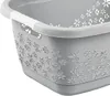 A close-up view of a grey laundry basket with a white handle and a decorative floral pattern embossed on its side. Anteprima dell’immagine prodotto