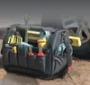 A Stanley FatMax tool bag filled with tools is placed on the ground next to a car tire. Anteprima dell’immagine prodotto