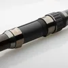 A close-up shot of a fishing rod handle with metallic accents. Produktbild-Vorschau