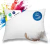 A white pillow with colorful powder exploding behind it. Náhľad obrázku produktu