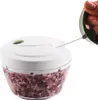A hand is pulling the cord of a manual food chopper filled with chopped red onions. Náhled obrázku produktu