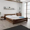 A bedroom scene with a wooden bed, nightstand, and dresser. Náhled obrázku produktu