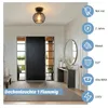 A hallway with a black door, a bench, a console table with a mirror, and a ceiling light. Produktbild-Vorschau