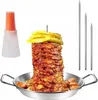 A vertical rotisserie grill set with meat, skewers, and a sauce bottle. Produktbild-Vorschau
