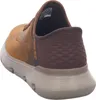 A rear view of a brown Skechers slip-on sneaker against a white background. Voir les images du produit