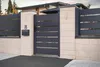 A modern gray aluminum garden gate with horizontal slats, set within a beige stone wall and pillars. A black mailbox is attached to one of the pillars, and the house number '8' is visible above it. Produktbild-Vorschau
