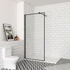 A modern bathroom with a walk-in shower, toilet, and framed artwork. Produktbild-Vorschau