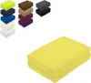 A stack of folded yellow fitted sheets in the foreground, with smaller stacks of fitted sheets in various colors in the background. Produktbild-Vorschau