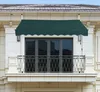 A green awning is installed above a balcony door on a building. Náhled obrázku produktu