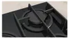 A close-up view of a black gas hob with a cast iron grate. Anteprima dell’immagine prodotto