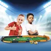 Two boys are playing with a toy race track with cars on a soccer field. Náhľad obrázku produktu