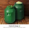 Two green fermentation barrels filled with food items, set against a wooden background. Produktbild-Vorschau