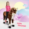 A young girl is riding a large plush horse in a whimsical, cloud-like setting. Podgląd zdjęcia produktu